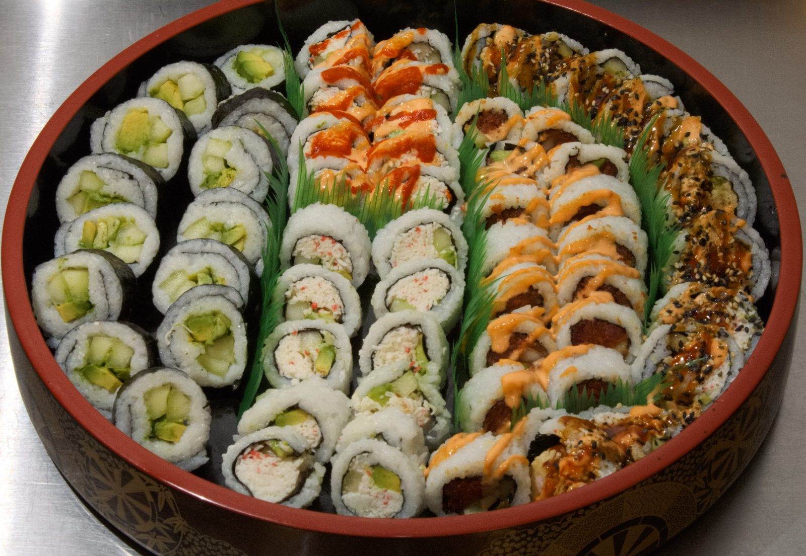 Sushi platter of vegetable, California and spicy rolls in rows