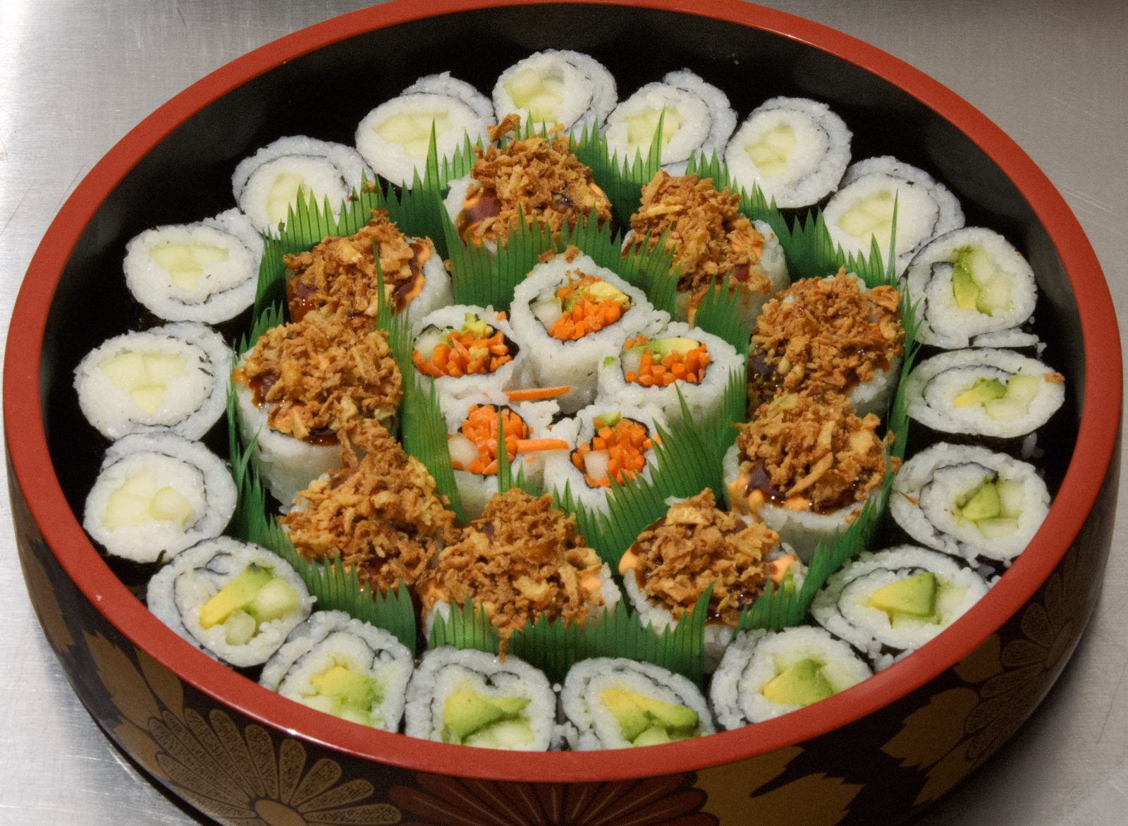 Vegetarian sushi tray with cucumber, avocado and carrot rolls